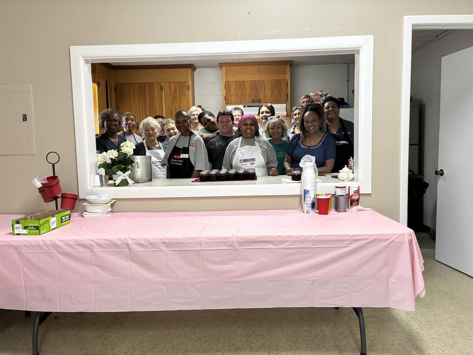 people standing in a kitchen after a canning class