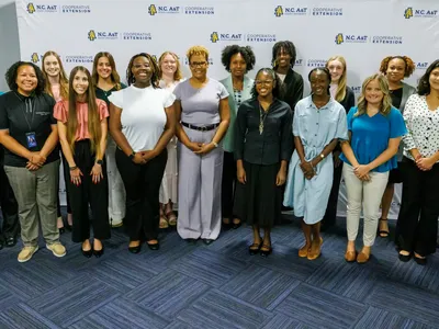 A group of people standing together posing for a picture.