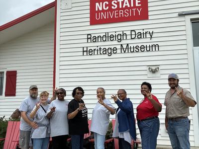 Richmond County EMFVs standing in front of a building during their tour of the NCSU dairy farm