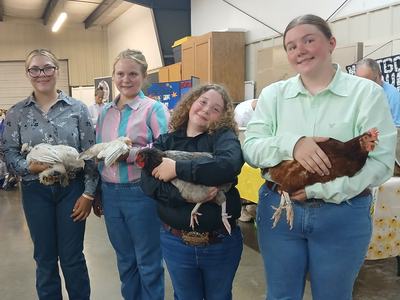 Four 4-H'ers pose with their chickens