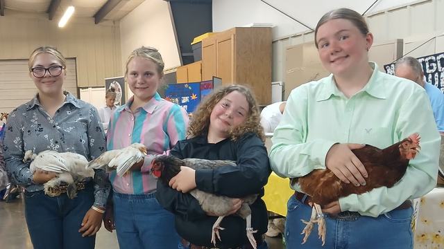 Four 4-H'ers pose with their chickens