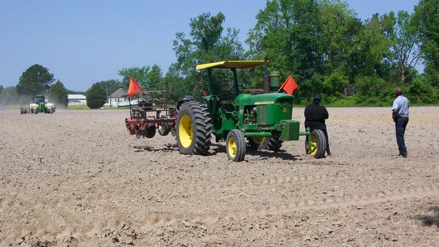 Image of tractor in a field preparing to plant