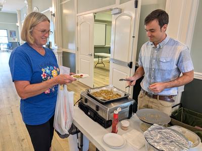 Avery handing out green bean fries at event.