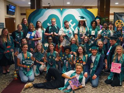 A group of graduating North Carolina 4-H seniors pose together with their decorated graduation caps during the inaugural 4-H Signing Season celebration at the 2026 North Carolina 4-H Congress.