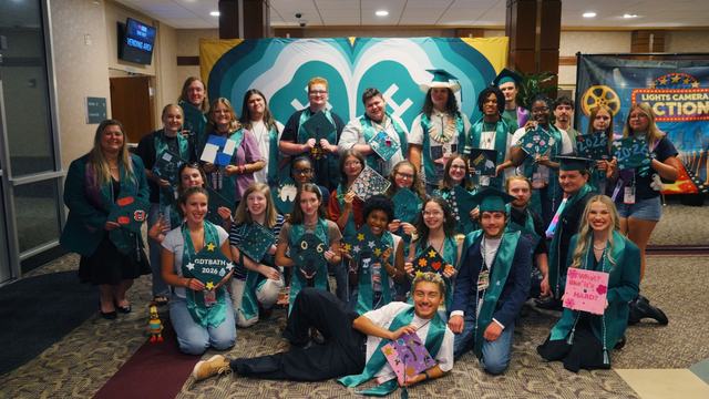 A group of graduating North Carolina 4-H seniors pose together with their decorated graduation caps during the inaugural 4-H Signing Season celebration at the 2026 North Carolina 4-H Congress.