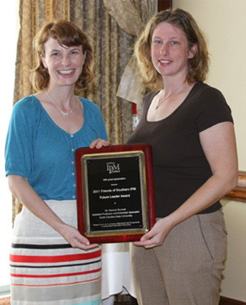 Dr. Danesha Seth Carley (right) presenting plaque to Dr. Hannah Burrack (left)