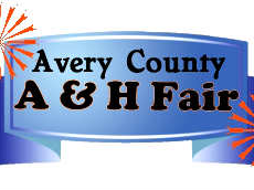 Banner reading "Avery County A & H Fair" on a blue ribbon with orange fireworks