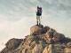 person standing on top of a mountain