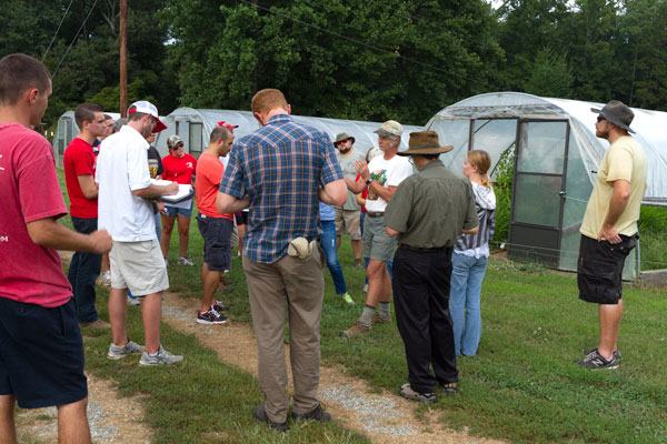  Talking about crop rotation in the sliding high tunnels.