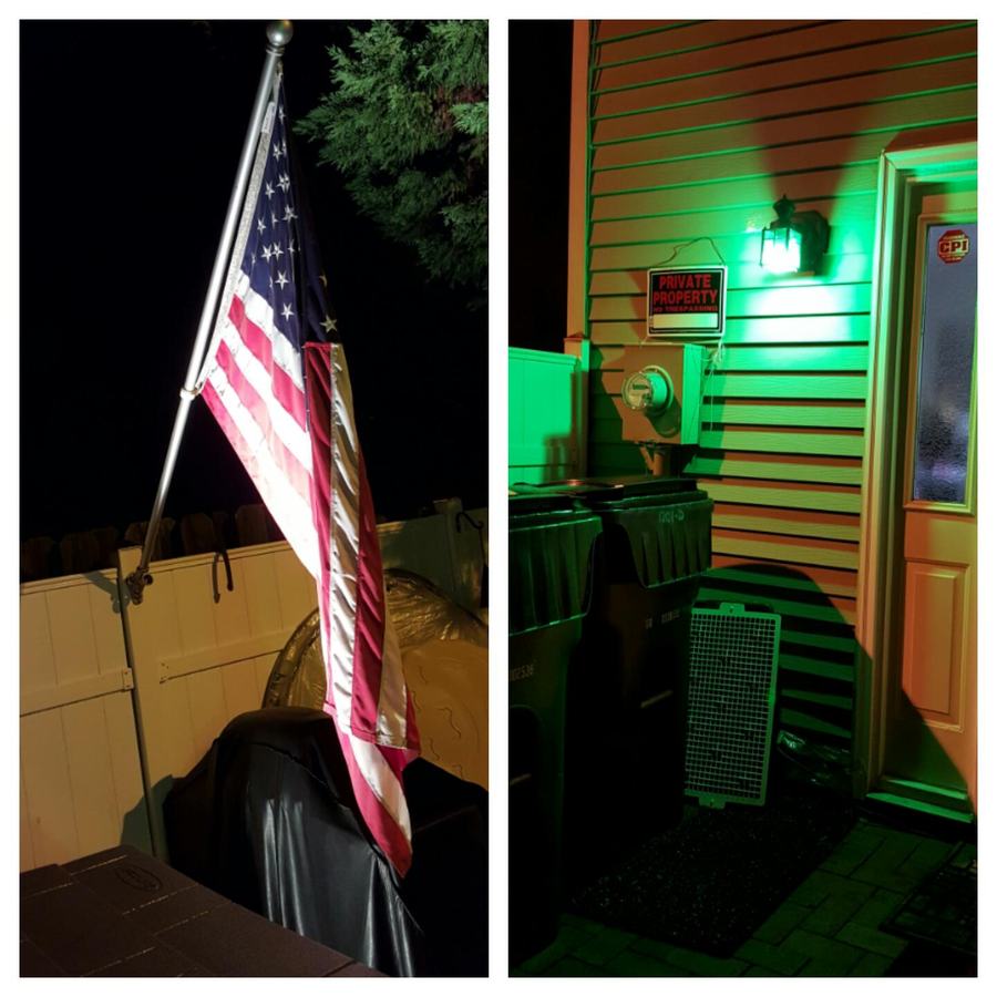 American flag on a pole at night; house siding with green light, trash bins and sign "PRIVATE PROPERTY"