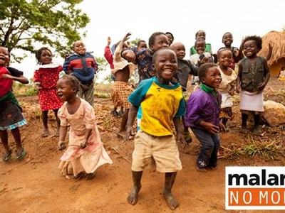 Children jumping and playing outside a thatched hut; logo reads "malaria NO MORE"