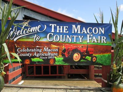 The Macon County Fair sign with tractor; reads "Celebrating Macon County Agriculture Since 1953"