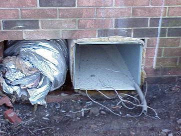 Exposed ductwork in foundation where AC unit has been removed.