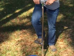 Woman taking soil sample.