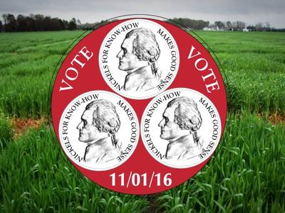 Red circular "VOTE" badge with three nickel profiles and date 11/01/16 over a grassy field