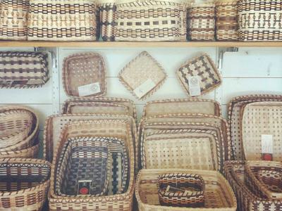 Shelves of woven baskets, various shapes stacked and nested on display