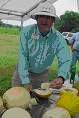 person slicing melons