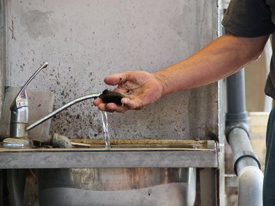 Man checking coagulation or flocculation to monitor polymer dosage