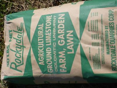 Bag labeled "Rockydale" agricultural ground limestone (dolomitic) — 50 lbs for farm/garden/lawn