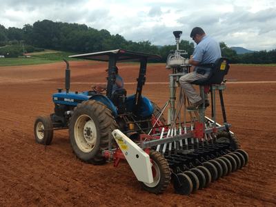 Man on planter planting industrial hemp seed.