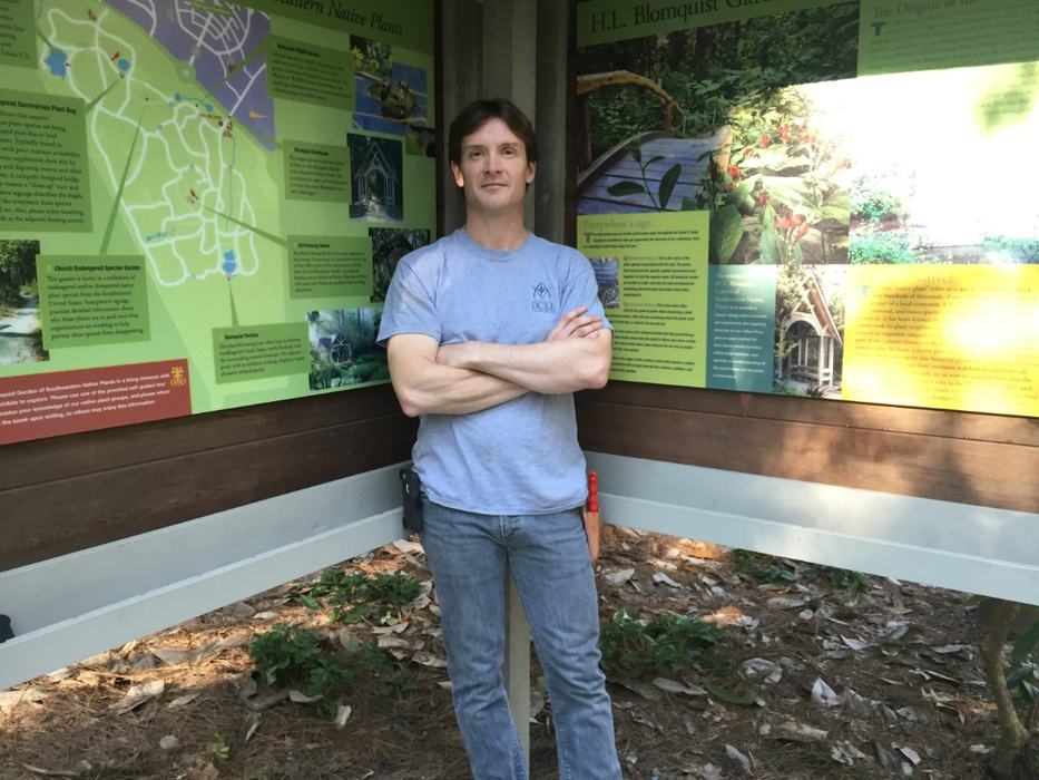 Stefan Bloodworth standing by garden map