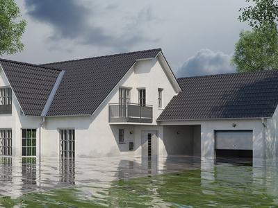 Two-story house with water flooding up to first-floor windows and garage