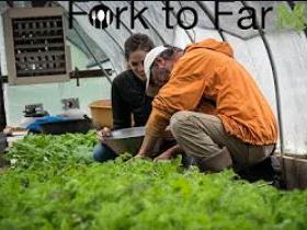 Two people harvesting greens in a greenhouse; sign reads "Fork to Farmer".