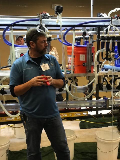 Image of man in front of dairy equipment