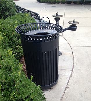 Water fountain and trash can in a park