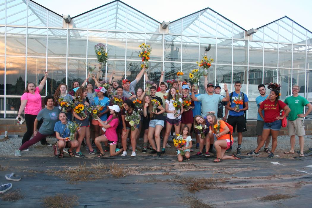 youth showing off floral arrangements