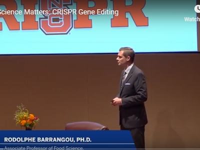 Man in suit standing on stage; caption reads "RODOLPHE BARRANGOU, PH.D."