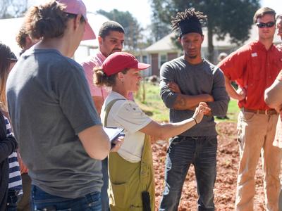 woman teaching farm school participants