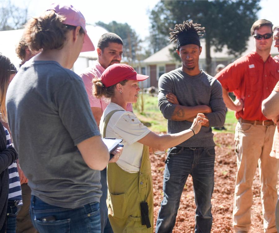 woman teaching farm school participants