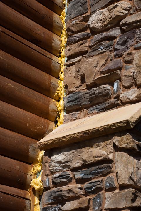 Chimney gap sealed with sprayable foam insulation