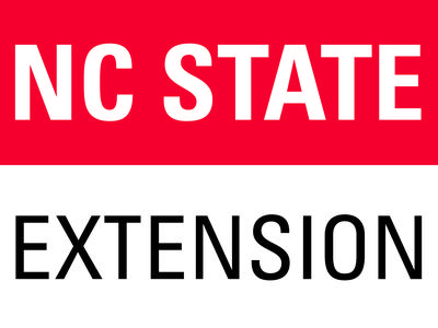 NC STATE in white on red band above black EXTENSION on white background