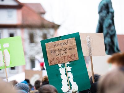 protest sign reading, "Respect our existence or expect resistance."