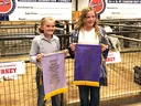 Caroline Scarlett and Laura Jessup holding champion banners