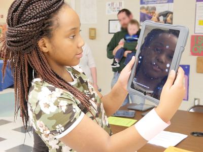 Child looking at ipad displaying astronomy app