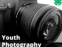 Close-up DSLR camera lens with text "Youth Photography" and 4-H clover logo