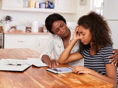 Mother Helps Stressed Teenage Daughter With Homework