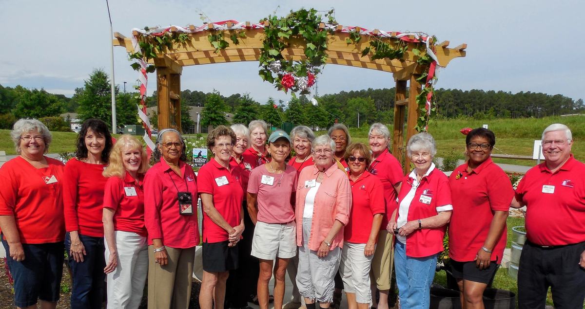 A group of Master Gardener volunteers at the entrance to the Memorial Garden project. 