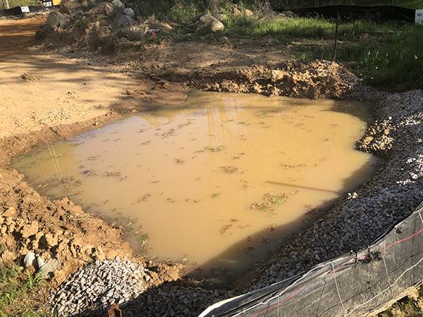 silt fence with water trapped to prevent run-off into nearby river
