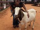 Lisa Gonzalez standing next to goat.