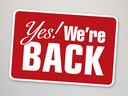 Red rectangular sign reading "Yes! We're BACK" with white border