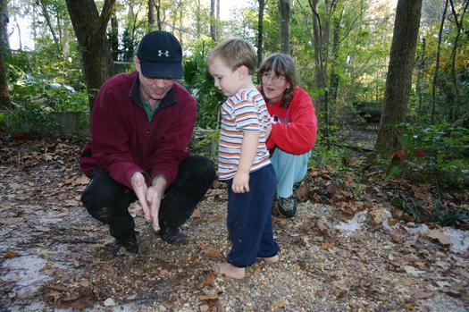Child with two adults outside