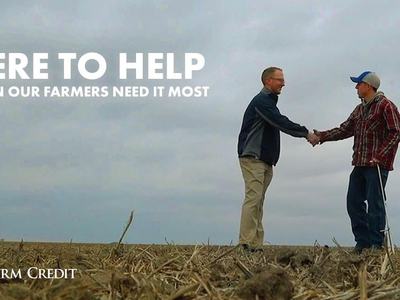 two men shaking hands in a field with the text Here to Help When Our Farmers Need It Most