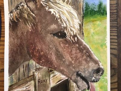 Brown horse poking head from stall with tongue out; "Roxy" written on wood