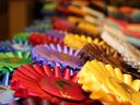Colorful rosette award ribbons arranged in overlapping rows
