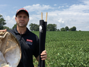 Man holding a sweep net and a drop cloth