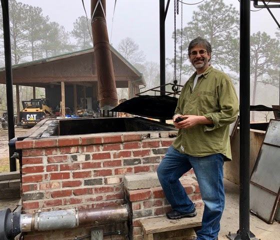 man in front of brick kiln